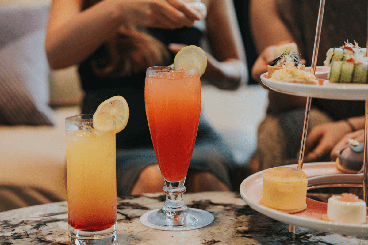Colorful cocktails and desserts on a table.