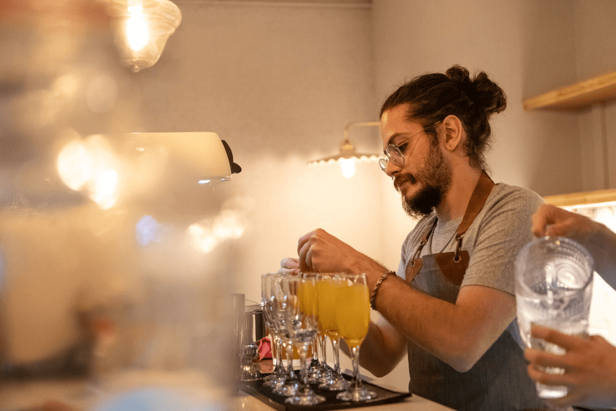 Bartender preparing drinks behind the counter.